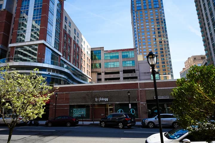 Wide view of Leafology on Main Street White Plains with high-rise residential tower above