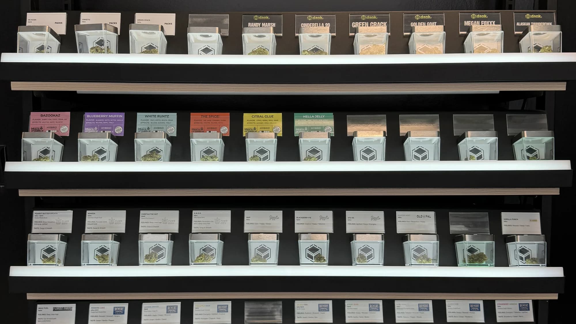 Leafology flower wall: four tiered shelves of packaged cannabis jars