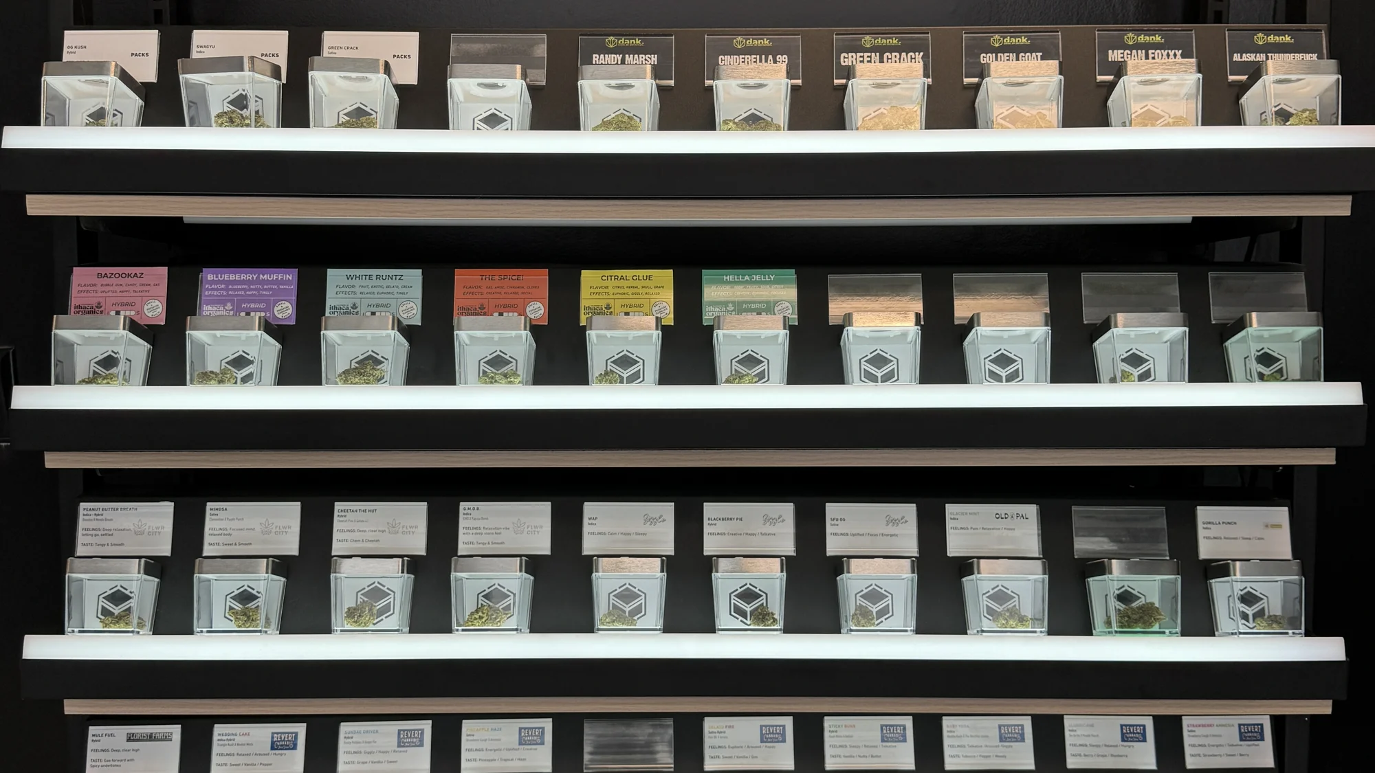 Leafology flower wall: four tiered shelves of packaged cannabis jars